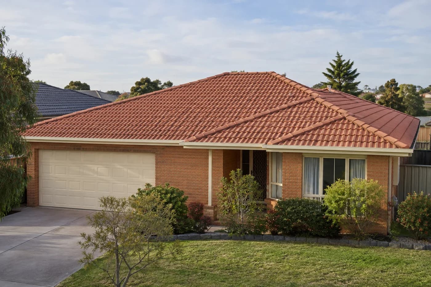 Terracotta tiled roof on an established brick home